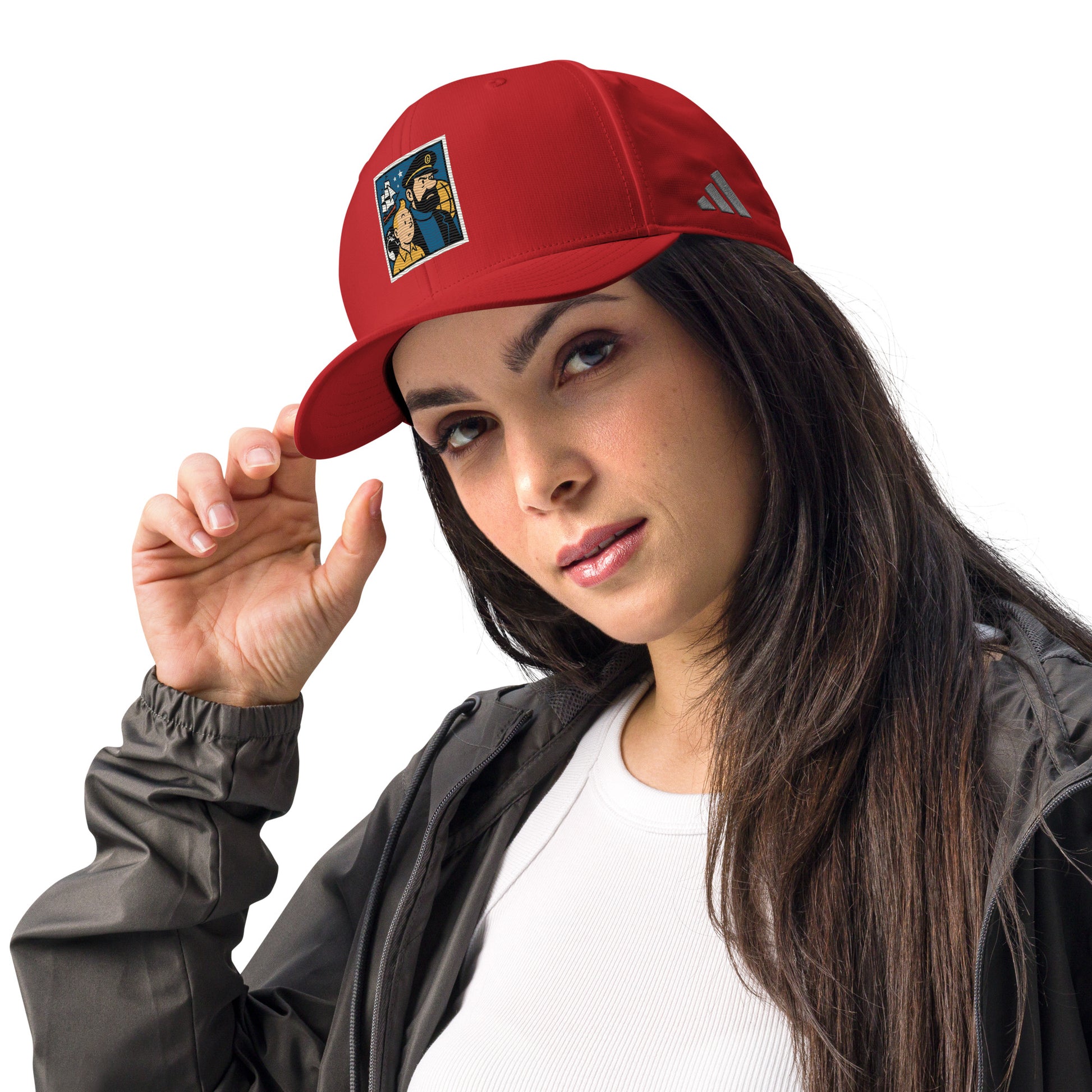 Woman wearing a red cap with a logo, posing against a white background