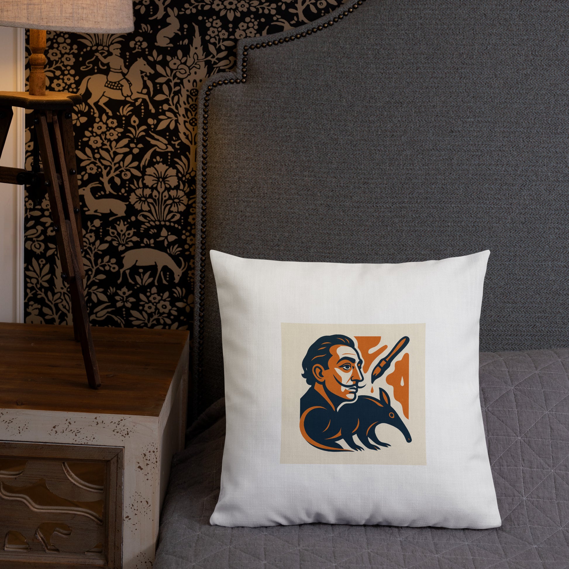 White pillow with a graphic design of Salvador Dali holding a rifle on a gray couch.