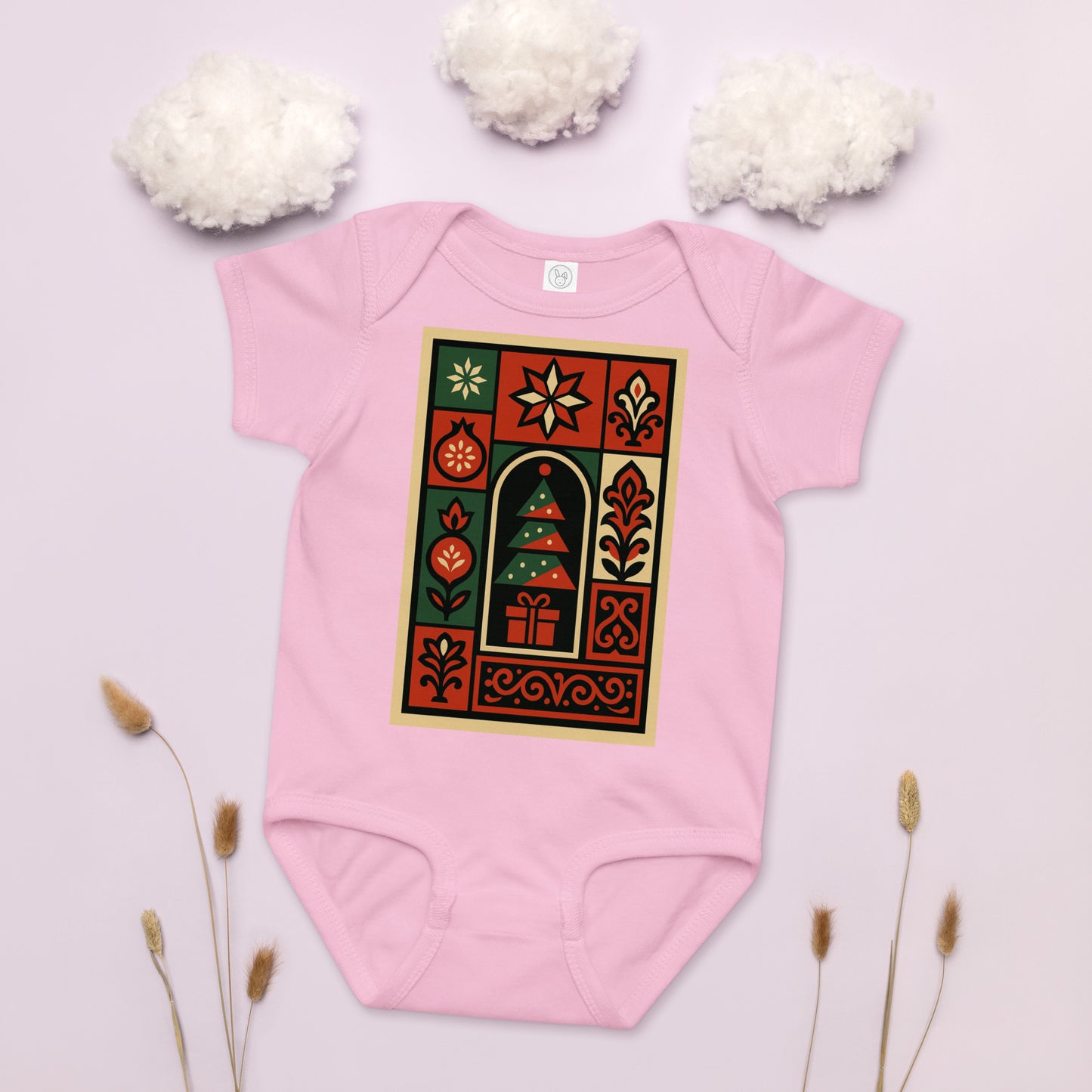 Pink baby onesie with a festive design on a light pink background with decorative elements.