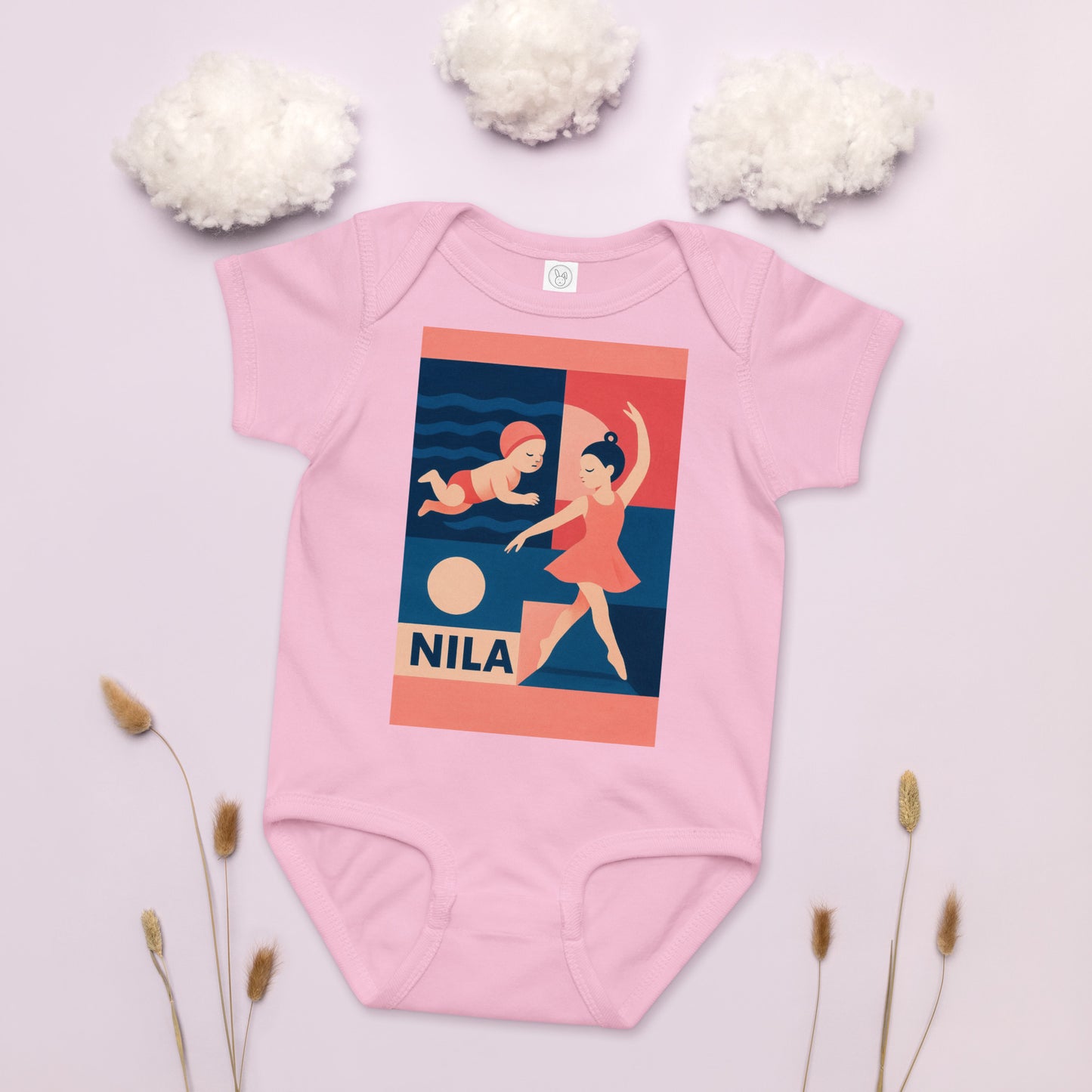 Pink baby onesie with graphic design and 'Nila' branding on a light background