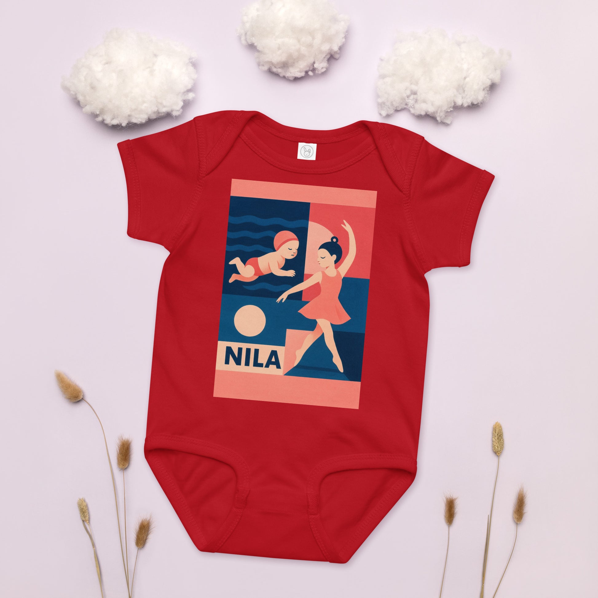 Red baby onesie with a graphic design and 'Nila' branding on a light background.