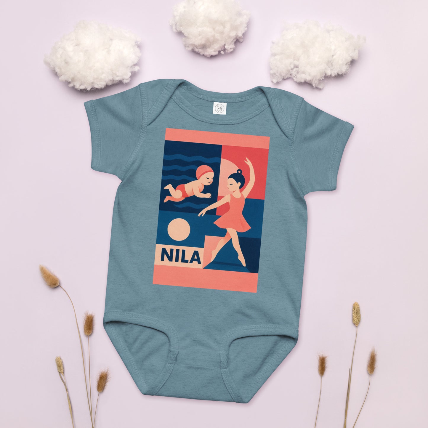 Teal baby onesie with a graphic design on a light pink background