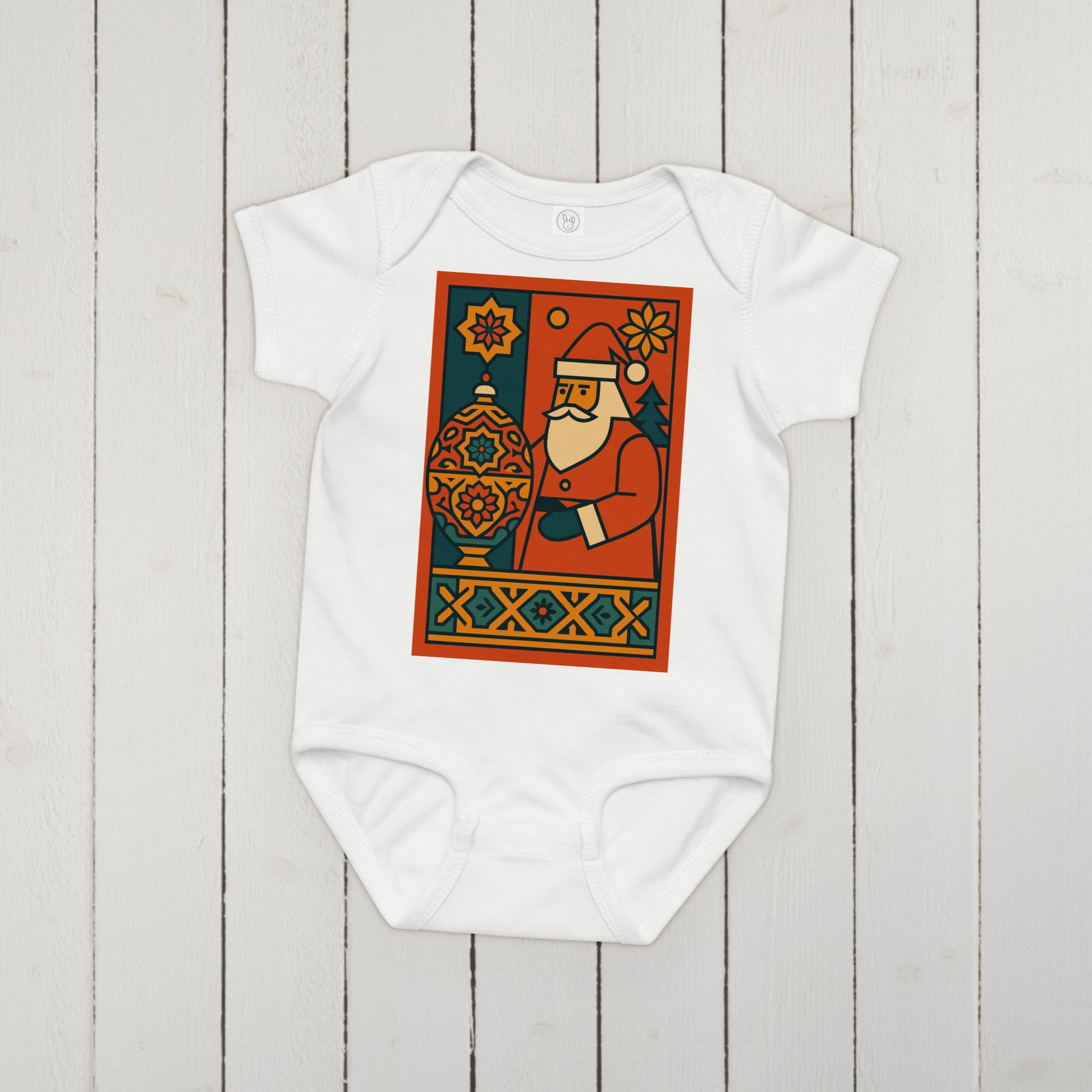 White baby onesie with a colorful graphic of Santa Claus on a wooden surface