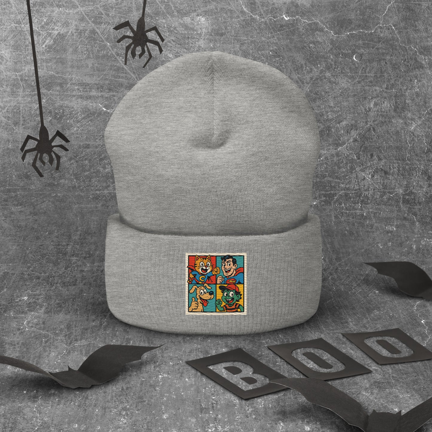 Gray beanie with a colorful patch on a textured gray background with spider decorations.