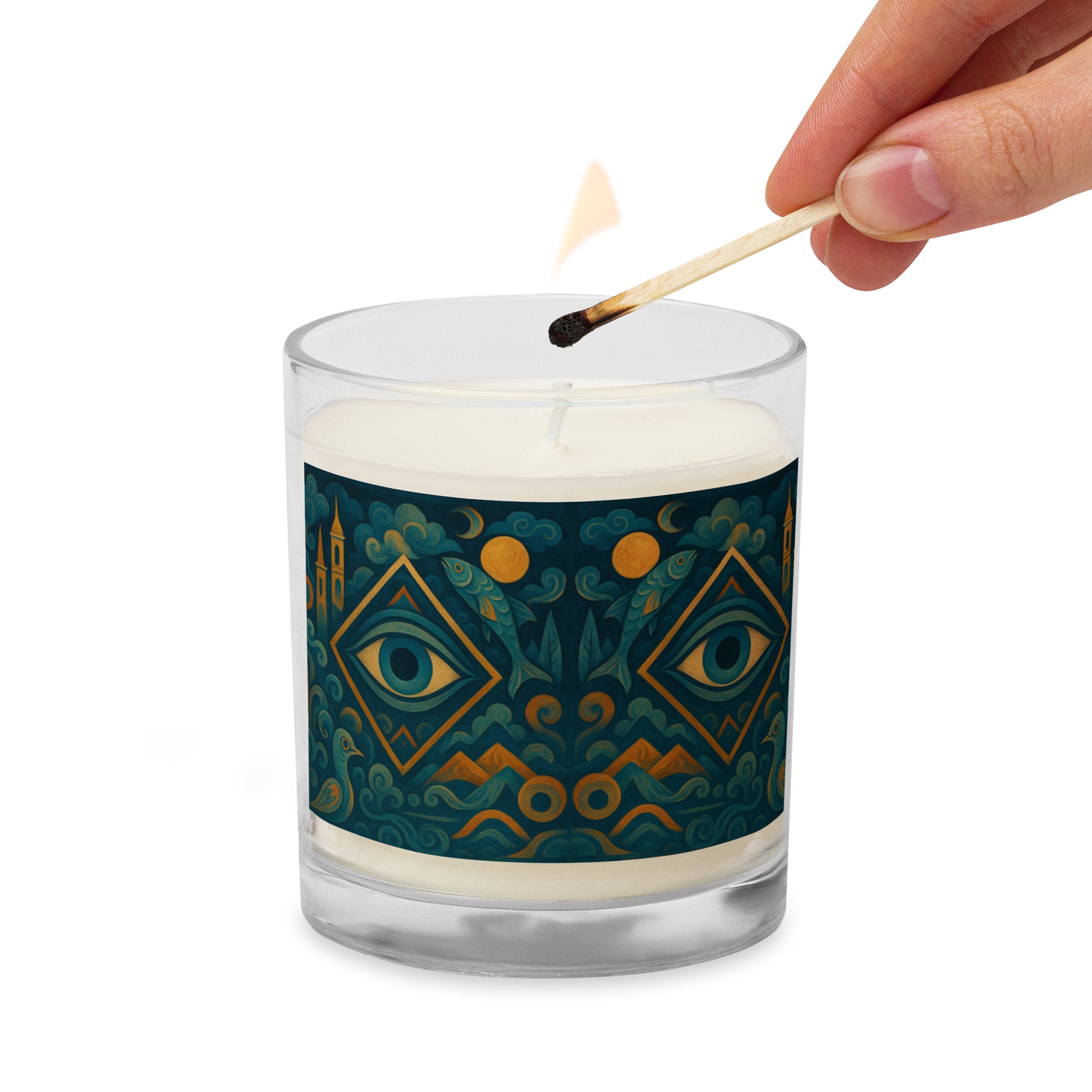 Candle with decorative label being lit by a match on a white background