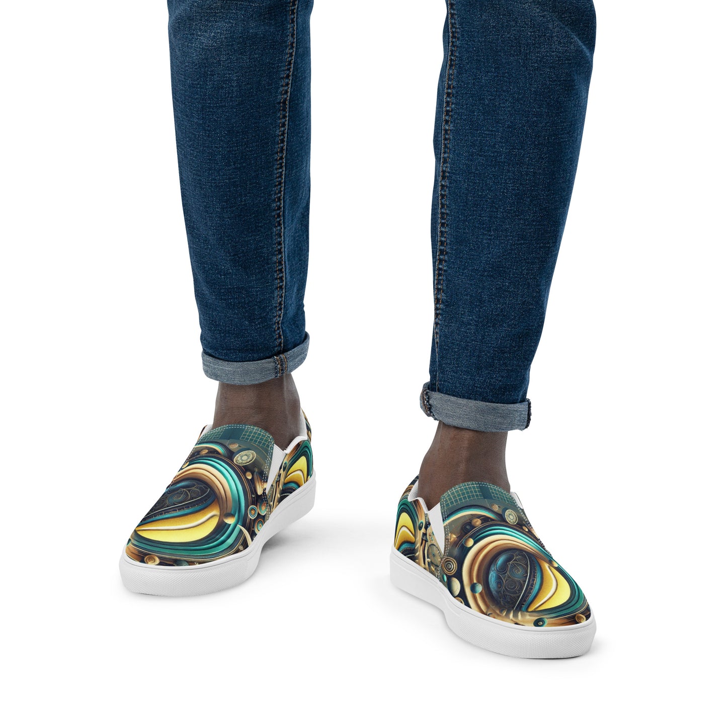 Colorful slip-on shoes with abstract design worn with blue jeans on a white background