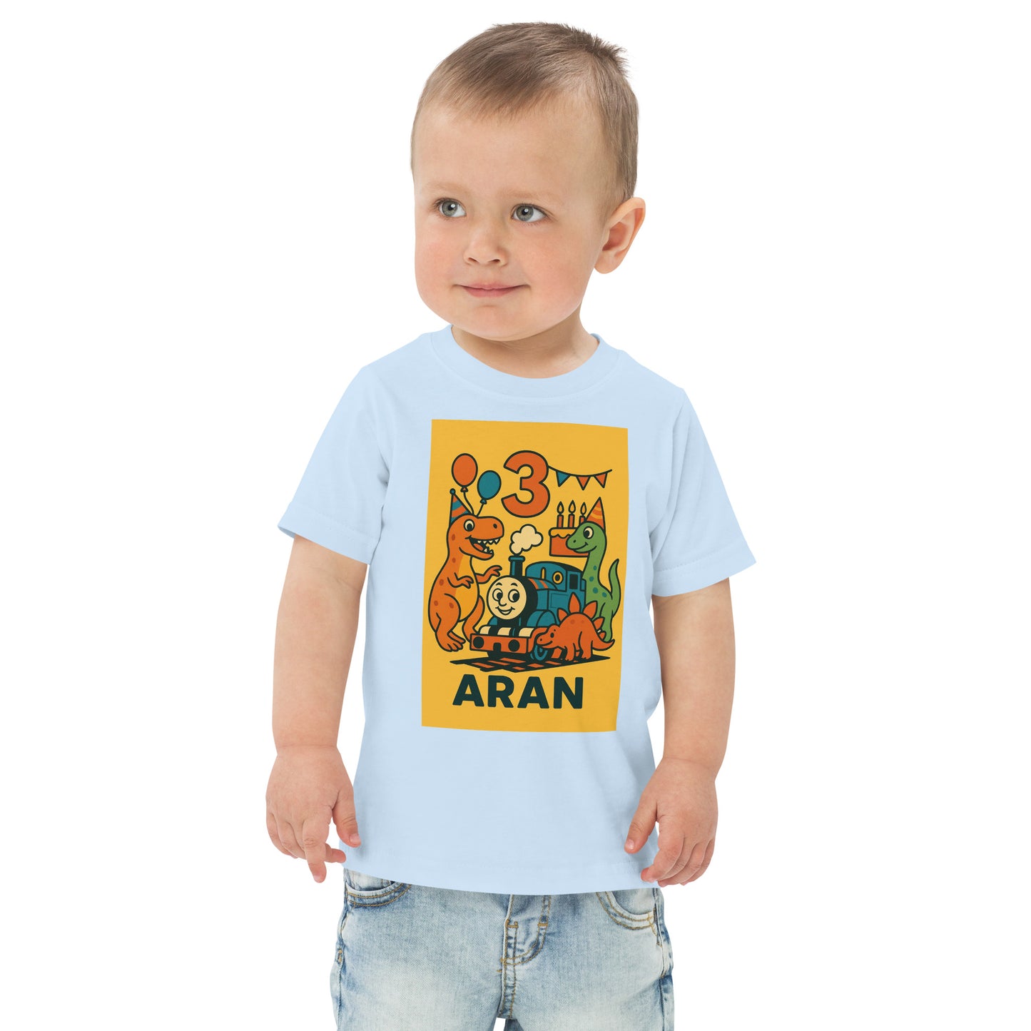Child wearing a light blue t-shirt with dinosaur graphics and text on a white background