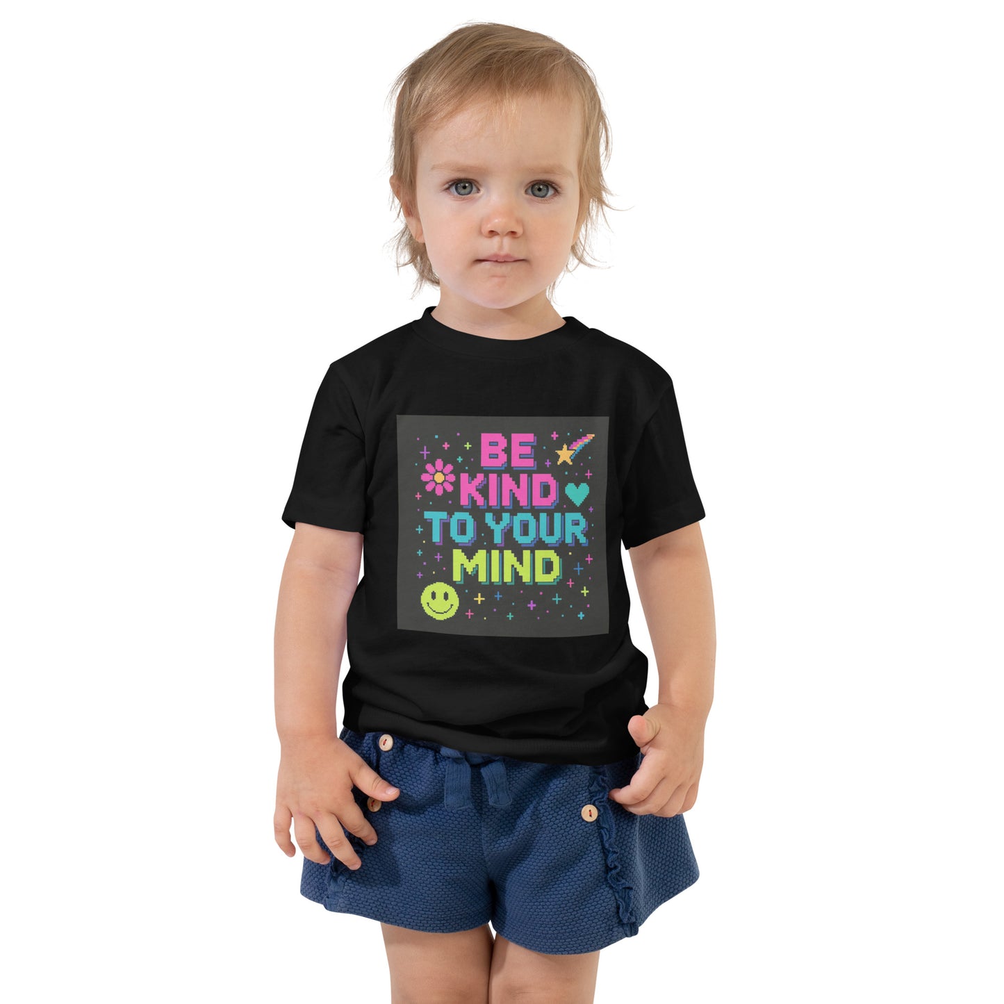 Child wearing a black t-shirt with 'Be Kind To Your Mind' text and smiley face design.
