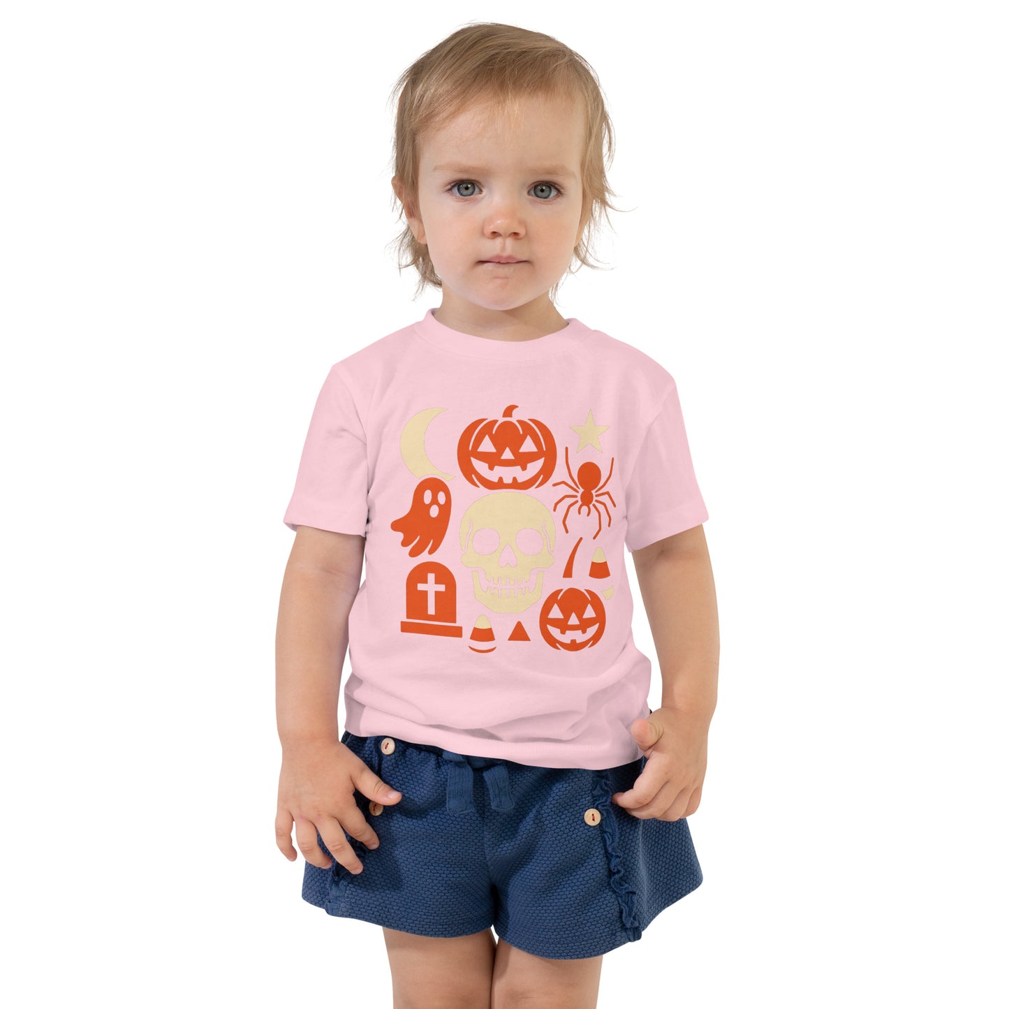 Child wearing a pink Halloween-themed t-shirt with graphics on a white background