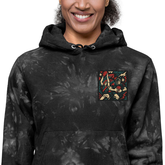 Person wearing a black tie-dye hoodie with a colorful graphic on the chest against a white background