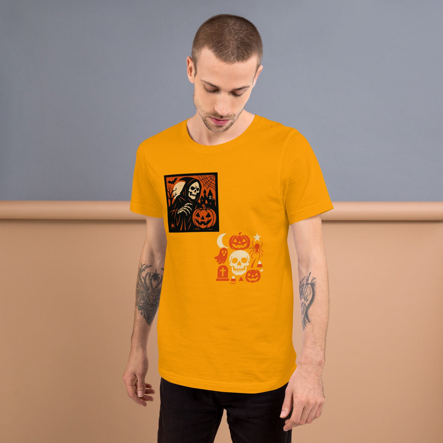 Man wearing a mustard yellow t-shirt with Halloween-themed graphics against a plain background