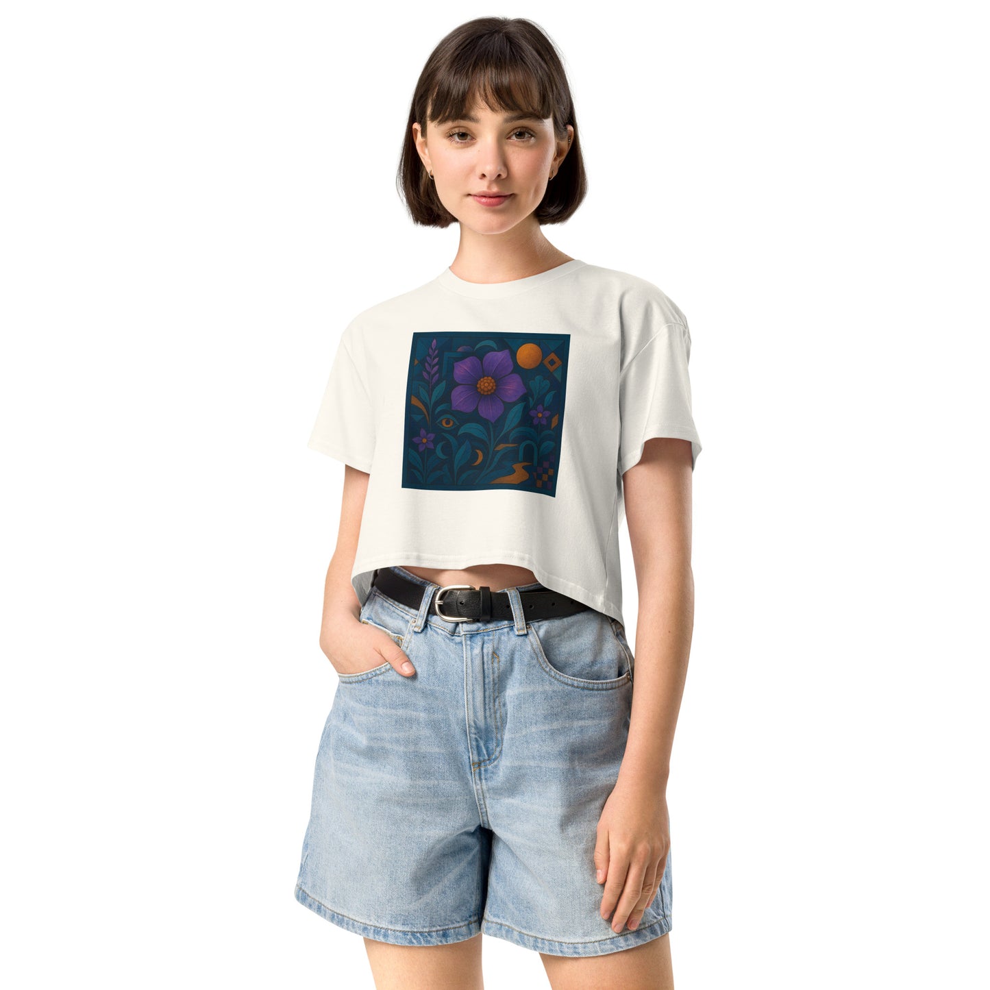 Person wearing a white t-shirt with a colorful graphic and denim shorts on a white background