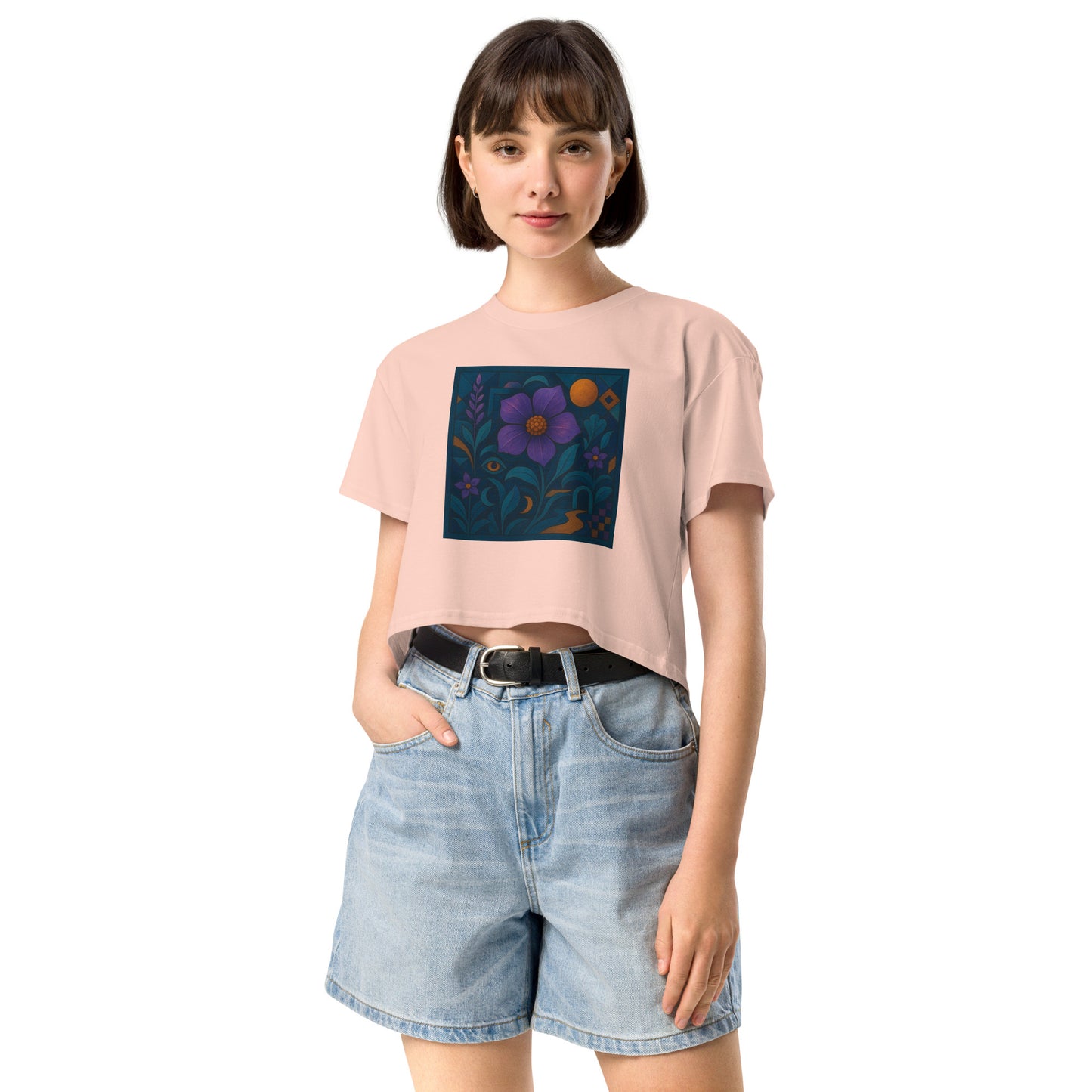 Person wearing a pink t-shirt with a colorful flower design and denim shorts on a white background