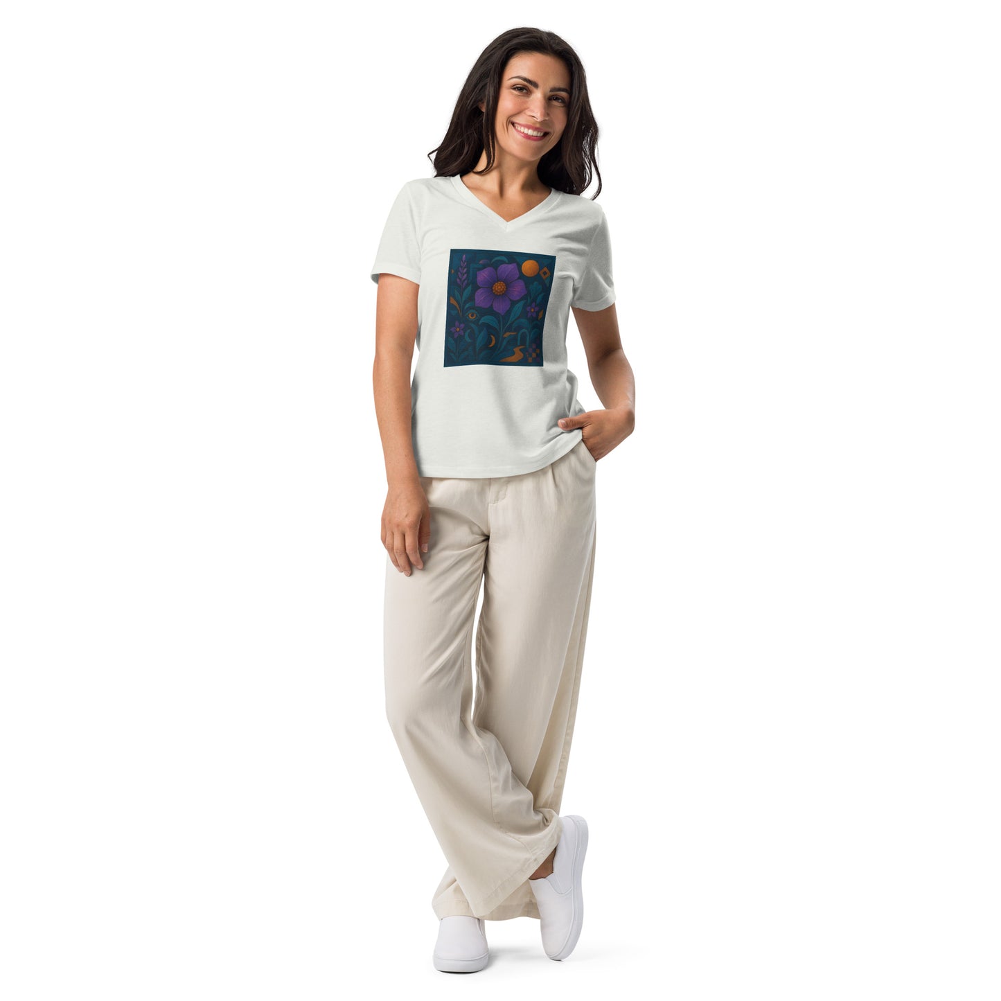 Woman wearing a white t-shirt with a colorful floral design and beige pants on a white background