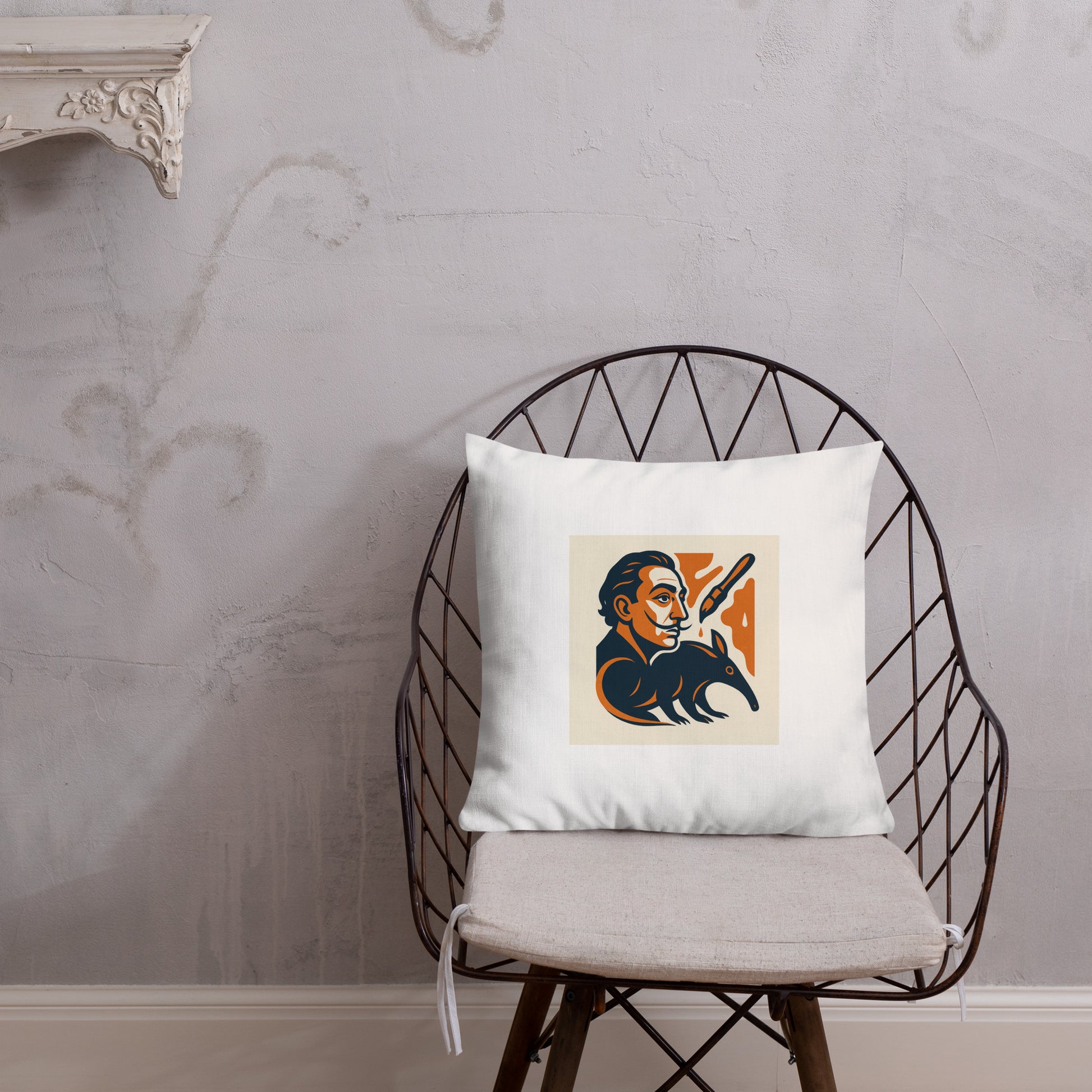 White pillow with a graphic design on a black wire chair against a gray wall.