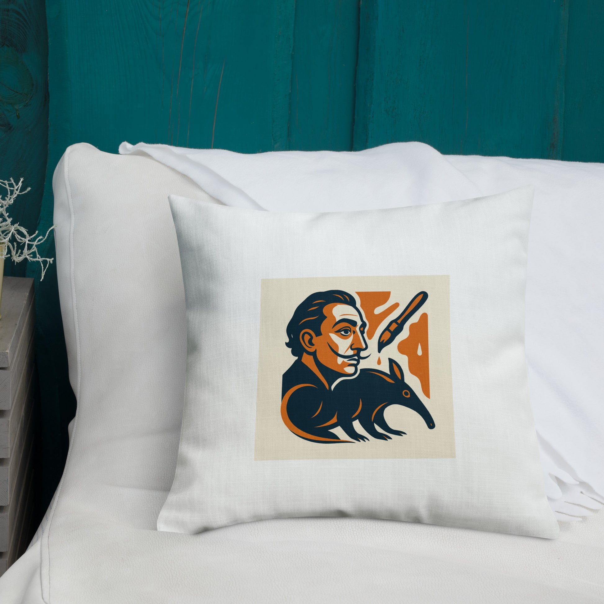Pillow with a graphic design of a stylized bear and person on a white pillow against a teal wall.