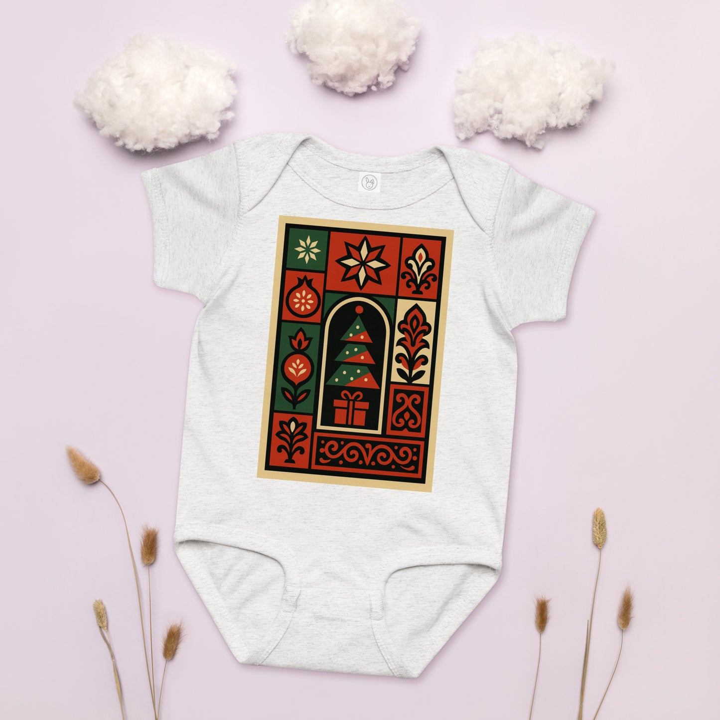 White baby onesie with a festive design on a light pink background