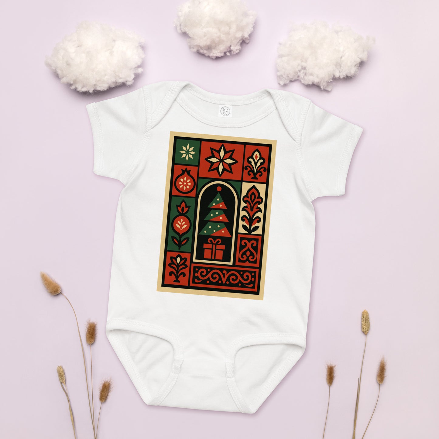 White baby onesie with a festive design on a light pink background
