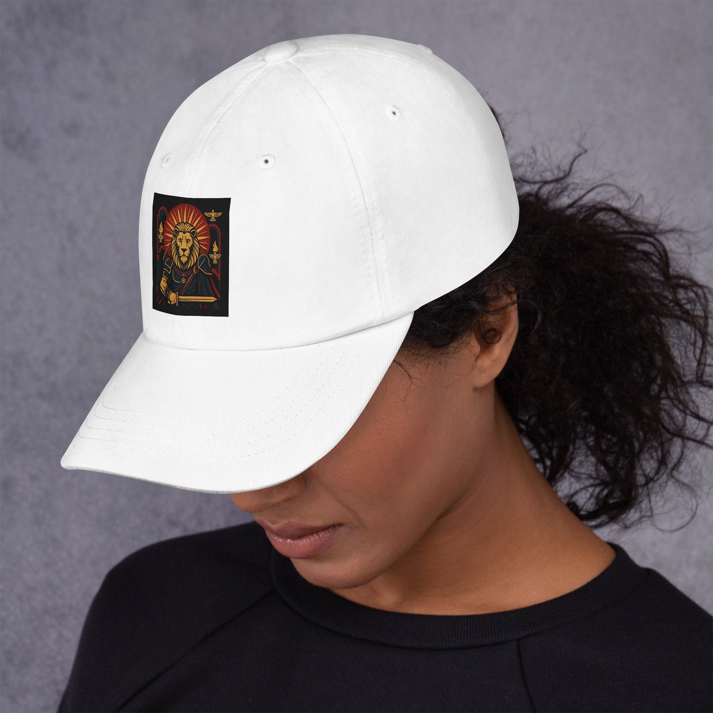 Person wearing a white cap with a logo on a gray background