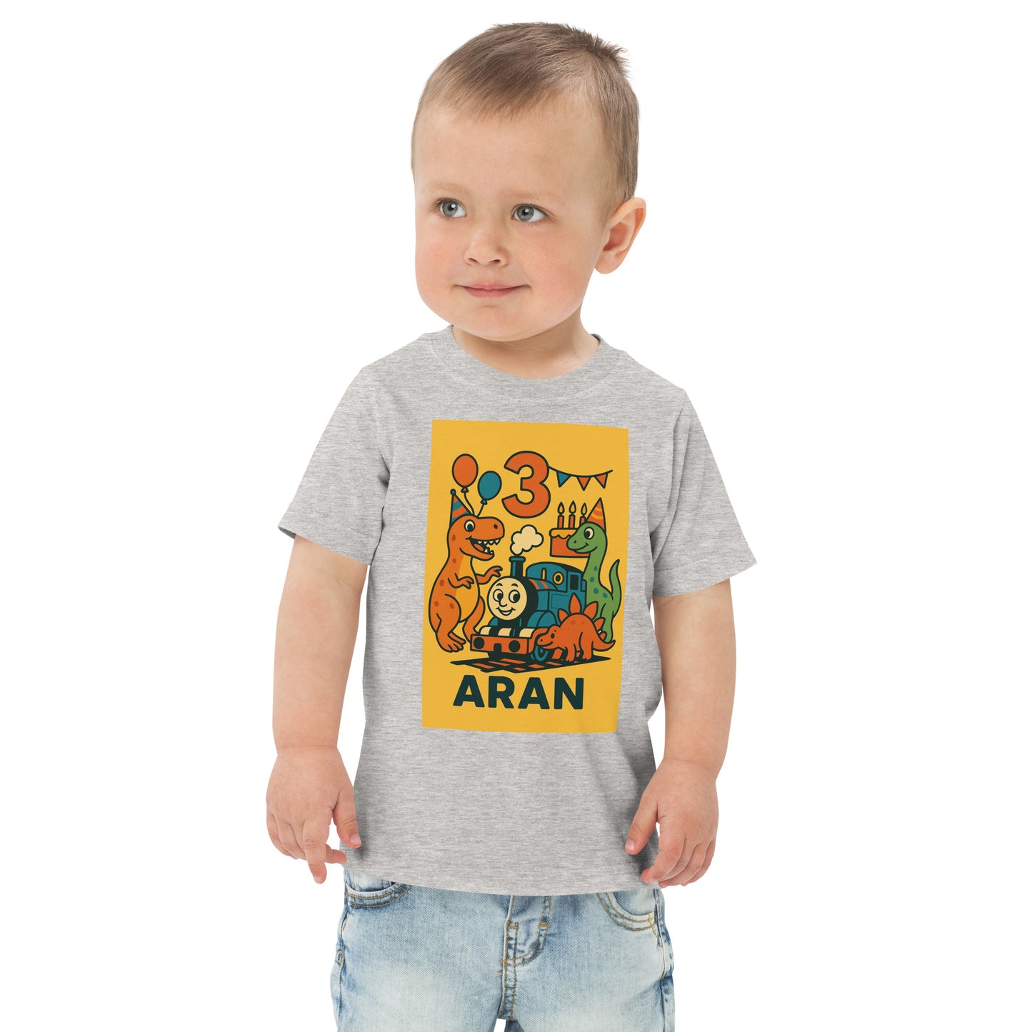 Child wearing a gray t-shirt with a colorful dinosaur design and text on a white background