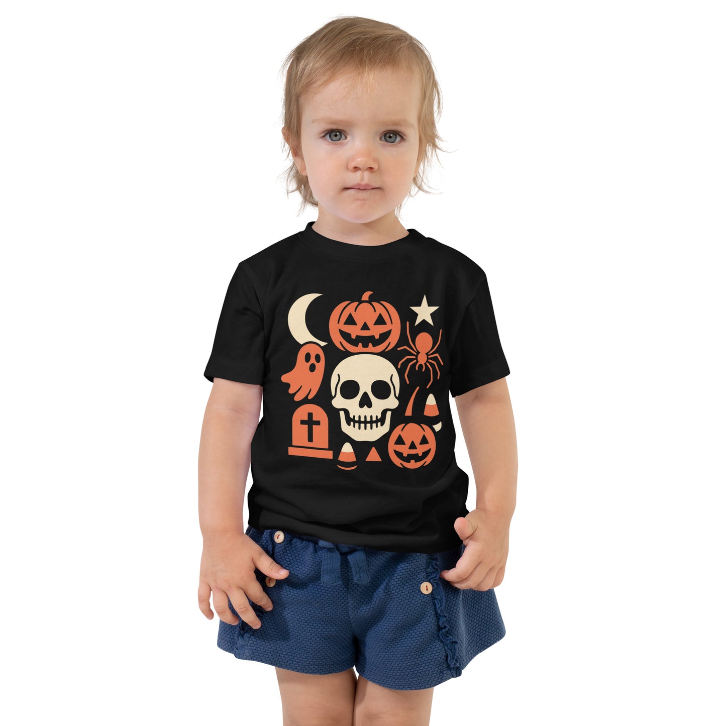 Child wearing a black t-shirt with Halloween-themed graphics on a white background