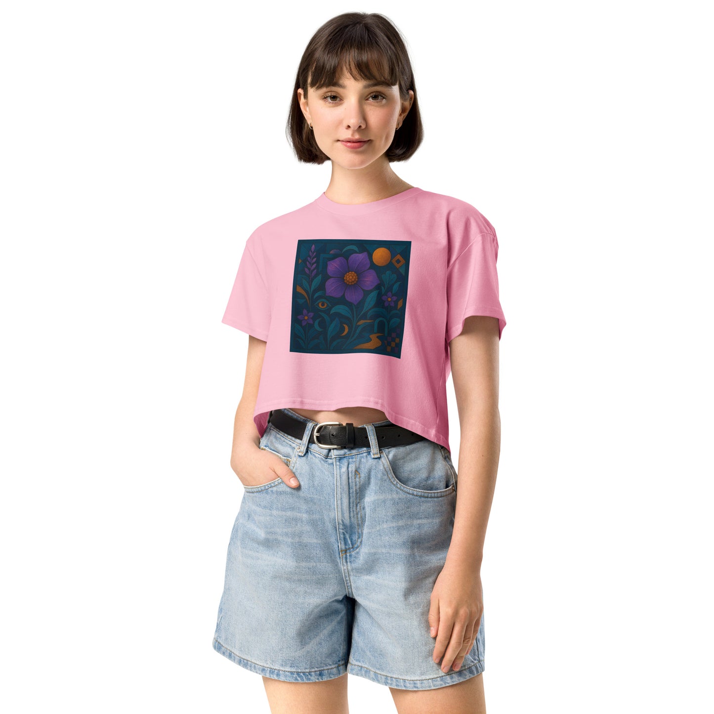 Person wearing a pink t-shirt with a colorful flower design and denim shorts on a white background